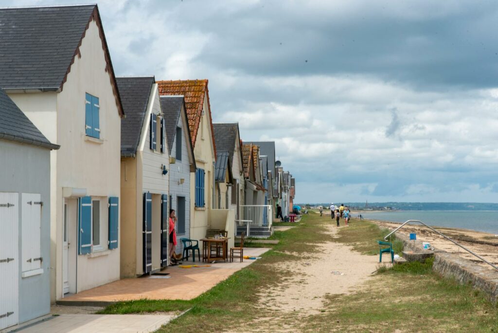 Picturesque beachside houses in Sainte-Mère-Église, Normandy, France on a cloudy day.